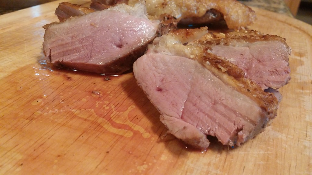 finished sliced duck on cutting board